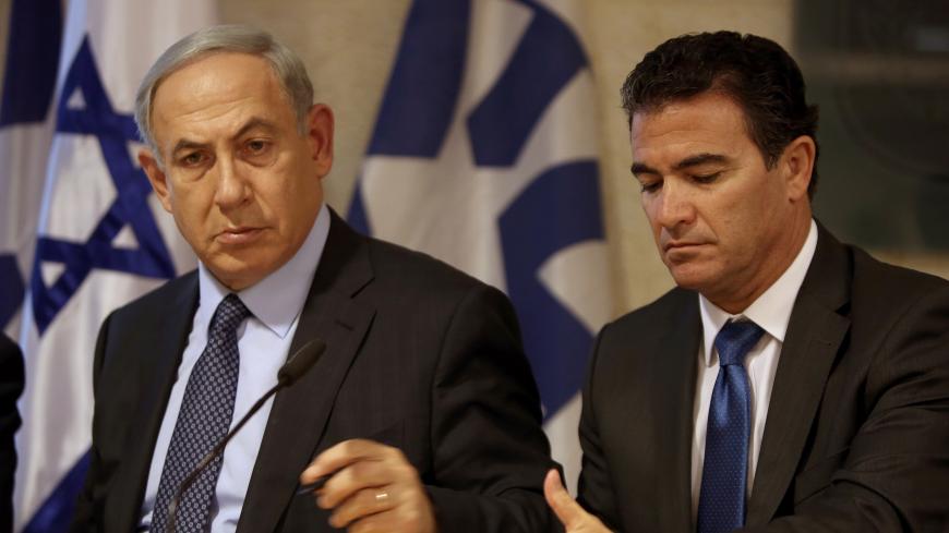 A file picture taken at the Israeli foreign ministry on October 15, 2015, shows Prime Minister Benjamin Netanyahu (L) sitting next to Yossi Cohen, who is currently the head of Israel's National Security Council, and who was named as the 12th head of the Mossad intelligence agency by Netanyahu on December 7, 2015. Cohen will take over from outgoing Mossad head Tamir Pardo, who will be leaving his post after five years next January. AFP PHOTO / GALI TIBBON / AFP / GALI TIBBON        (Photo credit should read 
