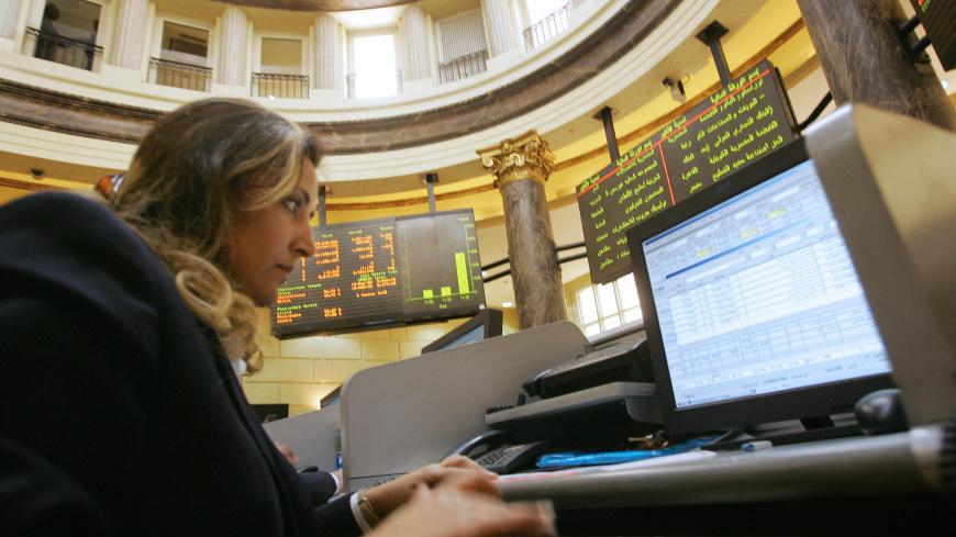 Cairo, EGYPT:  An Egyptian trader works on her computer in the Cairo Stock Exchange 15 March 2006. The three-year boom in Arab stocks appears to be ending as stocks in Dubai, Egypt, Jordan, Kuwait and Saudi Arabia, considered among the world's best performers since 2003, are sliding amid concerns that prices have outpaced the outlook for earnings grow. Egypt's index has lost 22 percent from its 01 Febuary 2006 peak. AFP PHOTO/KHALED DESOUKI  (Photo credit should read KHALED DESOUKI/AFP via Getty Images)