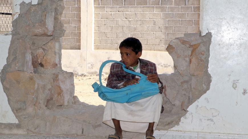 A Yemeni boy sits in a hole in a wall at a school that was damaged in the country's ongoing conflict between the Saudi-led Arab coalition fighting Shiite Huthi rebels in the northern province of Saada, on March 14, 2017.
The conflict in Yemen, which escalated with the intervention of the Saudi-led coalition two years ago, has more than doubled the number of children deprived of schooling to some 3.5 million, threatening the future of a whole generation in the impoverished country. / AFP PHOTO / STRINGER / T