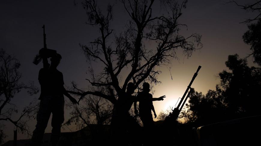TOPSHOT - Members of the Salah Bou-Haliqa brigade, loyal to the country's east strongman Khalifa Haftar's self-styled Libyan National Army, celebrate as they arrive in the eastern city of Benghazi after seizing the central al-Jufra area from the Benghazi Defence Brigades coalition, a rival to Haftar's forces on June 5, 2017. / AFP PHOTO / Abdullah DOMA (Photo credit should read ABDULLAH DOMA/AFP via Getty Images)