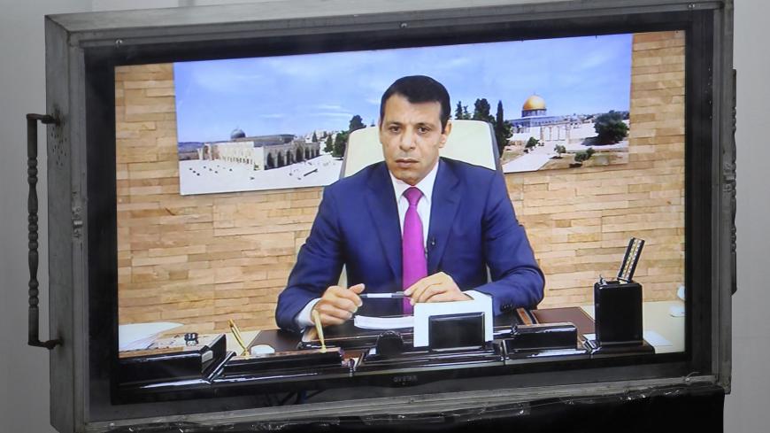 Exiled former senior Fatah member Mohammed Dahlan attends a Palestinian legislative Council meeting in Gaza City through video conference from the United Arab Emirates on July 27, 2017 following developments at the Al-Aqsa Mosque compound.

Palestinians were set to return to pray at a sensitive Jerusalem holy site after Israeli authorities removed controversial new security measures, potentially ending a nearly two-week crisis that sparked deadly unrest. Dahlan, Palestinian president Mahmud Abbas's exiled r