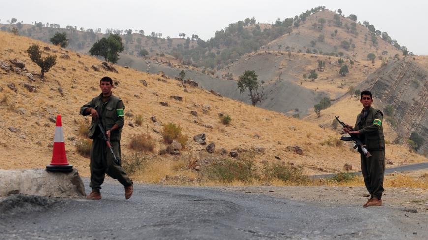 TO GO WITH AFP STORY BY NICOLAS CHEVIRON Kurdistan Worker's Party (PKK) rebels man a security checkpoint on October 28, 2009 near a PKK base in the Qandil mountains, near Rania province, in northern Iraq. From their bases in northern Iraq, the Kurdish guerilla movement is defying recent overtures of the Turkish government to reconcile with Turkey's 15 million Kurds, saying it is ready to wage a 50-year war against Ankara.                   AFP PHOTO / MUSTAFA OZER (Photo credit should read MUSTAFA OZER/AFP 