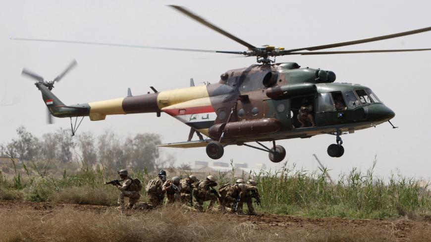 Iraqi soldiers take position as they disembark from an MI171 helicopter during a joint land and air training with US soldiers from 1st Air Cavalry Brigade at Camp Taji, 25kms north of Baghdad, on March 29, 2010. AFP PHOTO/AHMAD AL-RUBAYE (Photo credit should read AHMAD AL-RUBAYE/AFP via Getty Images)