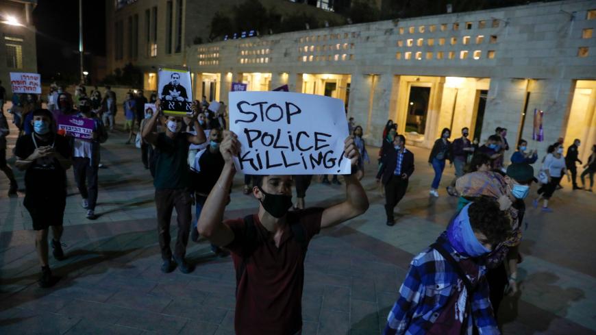 Israeli left-wing activists attend a protest against the killing of Iyad Hallak, a disabled Palestinian man shot dead by Israeli police, in Jerusalem on June 9, 2020. (Photo by Ahmad GHARABLI / AFP) (Photo by AHMAD GHARABLI/AFP via Getty Images)