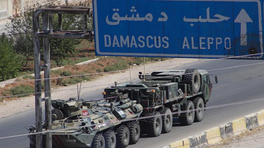 A Turkish-Russian military convoy tows a damaged vehicle after its joint patrol was reportedly targeted on the strategic M4 highway, near the Syrian town of Urum al-Jawz in the south of the northwestern Idlib province, on August 25, 2020. - Russia and Turkey launched joint patrols along the M4 highway in March following a ceasefire agreement aimed at stopping heavy fighting in and around Idlib, the last major bastion of anti-government forces in Syria's civil war. (Photo by Abdulaziz KETAZ / AFP) (Photo by 