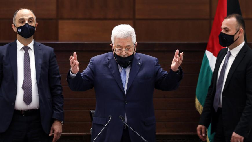 Palestinian president Mahmud Abbas (C), mask-clad due to the COVID-19 coronavirus pandemic, recites a prayer as he arrives for a meeting in the West Bank's Ramallah on September 3, 2020, with representatives of Palestinian factions there and with others by video conference gathered at the Palestinian embassy in Beirut in rare talks on how to respond to such accords and to a Middle East peace plan announced by Washington this year. (Photo by Alaa BADARNEH / POOL / AFP) (Photo by ALAA BADARNEH/POOL/AFP via Ge
