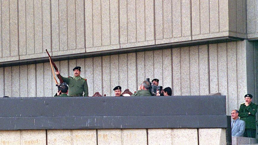 382543 02: Iraqi president Saddam Hussein raises his rifle in a salute and fires it November 20, 2000 durring Grand Day of Quds festivities in Baghdad. Grand Day of Quds celebrates Iraq''s commitment to liberating Jerusalem from Israeli rule. (Photo by Newsmakers