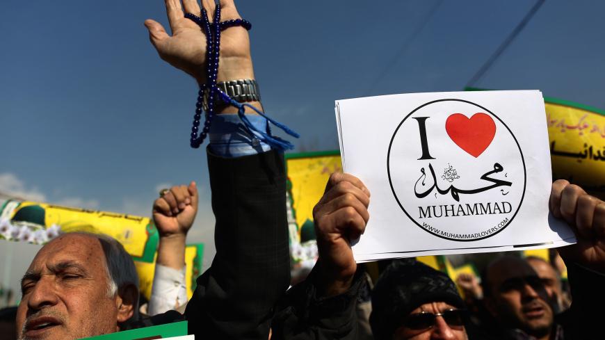 Iranian worshippers demonstrate after the weekly Friday prayers on January 23, 2015 in Tehran to protest against a cartoon of the Prophet Mohammed that was published by the French satirical magazine Charlie Hebdo in an edition issued a week after 12 people were killed by Islamist gunmen at its Paris offices. Iran denounced the attack on the offices of Charlie Hebdo but has also condemned as "insulting" and "provocative" its publication last week of a new cartoon of the Prophet Mohammed.  AFP PHOTO/BEHROUZ M