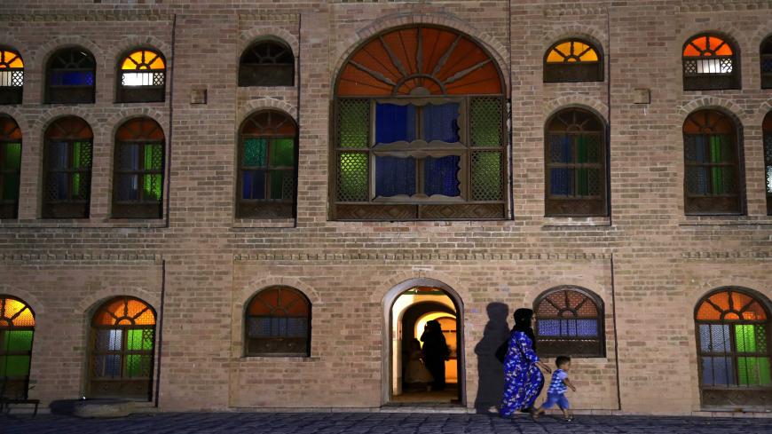 Iraqi tourists walk past the Sherwana Citadel in the Kurdish city of Kalar, 126 kms south of Sulaimaniya, on September 27, 2015. AFP PHOTO / SAFIN HAMED        (Photo credit should read SAFIN HAMED/AFP via Getty Images)