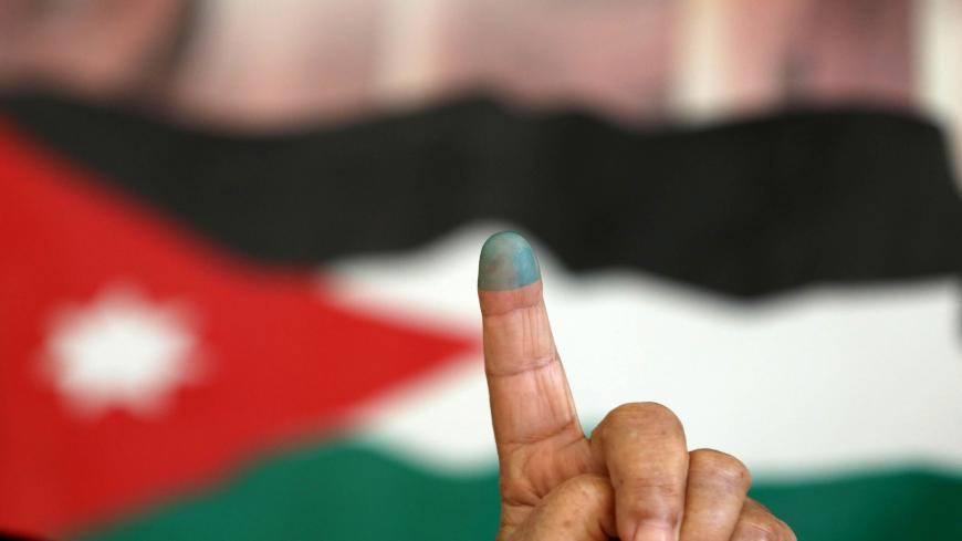 A Jordanian woman shows her ink-stained finger after casting her vote in the parliamentary elections at a polling station in the capital Amman on September 20, 2016.
Jordanians are voting in an election that could see opposition Islamists re-emerge as a major parliamentary force in the key Western ally.
/ AFP / Khalil MAZRAAWI (Photo credit should read KHALIL MAZRAAWI/AFP via Getty Images)