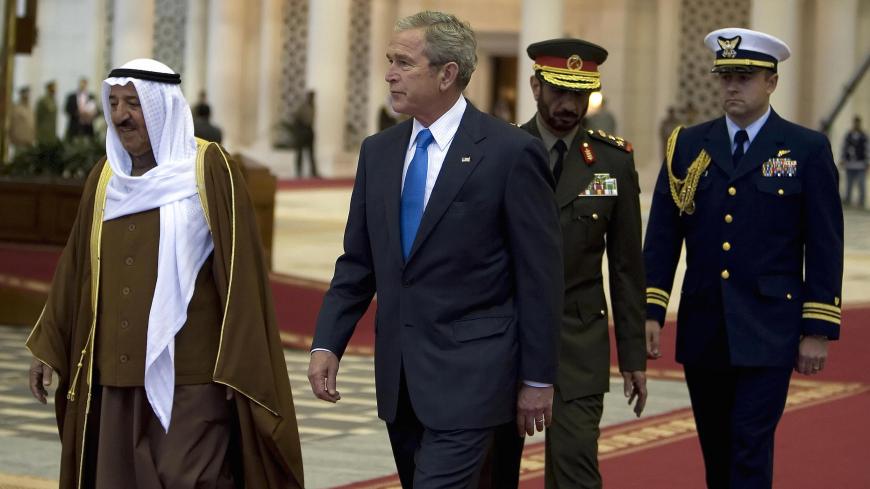 US President George W. Bush (C) and Emir of Kuwait Sheikh Sabah al-Ahmad al-Sabah (L) walk together during the arrival ceremony of the former at Kuwait International Airport in Kuwait City, 11 January 2008. US President George W. Bush arrived in Kuwait today to rally the support of Arab allies against what he calls the Iranian "threat," after making a bold prediction for Middle East peace. AFP PHOTO/JIM WATSON (Photo credit should read JIM WATSON/AFP via Getty Images)