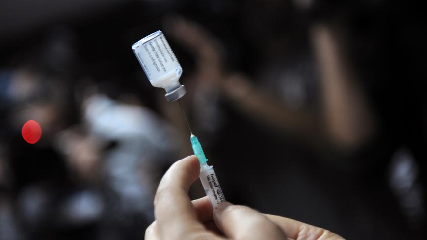 A nurse prepares a shot of the A(H1N1) vaccine (Pandemrix from Glaxo Smith Kline -GSK- laboratory) to a hospital staff member in Istanbul, on November 2, 2009. Turkey began vaccinating medical workers Monday as the death toll from the A(H1N1) virus in the country reached six, the health ministry said. The latest victims of the disease were a 22-month-old baby and a 14-year-old boy who died overnight in the central city of Konya, a ministry statement said. Nine other people infected with swine flu were in