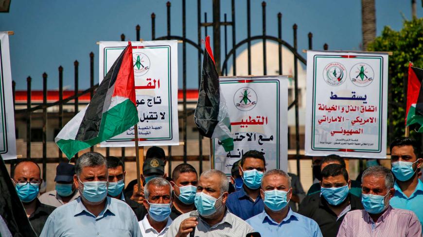 Demonstrators, mask-clad due to the COVID-19 coronavirus pandemic, attend a protest against the United Arab Emirates' and Bahrain's decisions to normalise relations with Israel, in Gaza City on September 15, 2020. - Palestinian leaders had earlier called for demonstrations against the "shameful" deals the United Arab Emirates and Bahrain are set to sign with Israel. Officials from both Gulf states are due to attend a ceremony at the White House on September 15 to formalise ties with Israel, prompting Palest