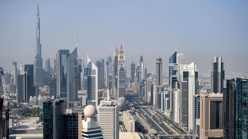 This picture taken on July 8, 2020 shows an aerial view of the Sheikh Zayed Road section of the E 11 highway and the Dubai Metro flyover in the Gulf emirate of Dubai, during a government-organised helicopter tour, with the Burj Khalifa skyscraper seen in the background. - Dubai reopened its doors to international visitors on July 7 in the hope of reviving its tourism industry after a nearly four-month closure. (Photo by KARIM SAHIB / AFP) (Photo by KARIM SAHIB/AFP via Getty Images)