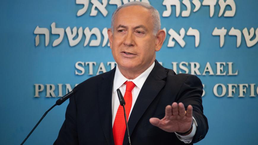 Israeli Prime Minister Benjamin Netanyahu gives a briefing on coronavirus developments in Israel at his office in Jerusalem, on September 13, 2020. - Israel's government announced it would impose a three-week nationwide lockdown in an effort to stem one of the world's highest novel coronavirus infection rates after a surge in cases. (Photo by Yoav Dudkevitch / POOL / AFP) (Photo by YOAV DUDKEVITCH/POOL/AFP via Getty Images)