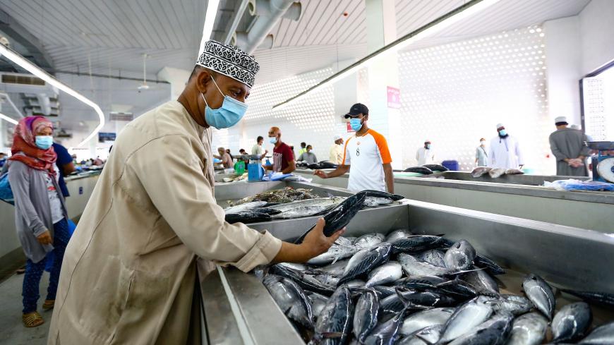 A vendor wearing a face mask against the coronavirus sells fresh fish at the Mutrah Souq (Mutrah market) in the Omani capital Muscat on September 18, 2020. (Photo by Haitham AL-SHUKAIRI / AFP) (Photo by HAITHAM AL-SHUKAIRI/AFP via Getty Images)