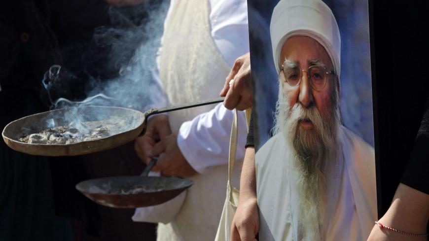 Iraqi Yazidis burn incense during the funeral of Baba Sheikh Khurto Hajji Ismail (image), supreme spiritual leader of the Yazidi religious minority, in the Iraqi town of Sheikhan, 50km northeast of Mosul, on October 2, 2020. - Iraq's Yazidi minority laid to rest their spiritual leader today as tributes poured in for the man who guided his flock through the horrors of Islamic State group occupation.
Baba Sheikh Khurto Hajji Ismail died late yesterday at the age of 87, his office said. (Photo by SAFIN HAMED /