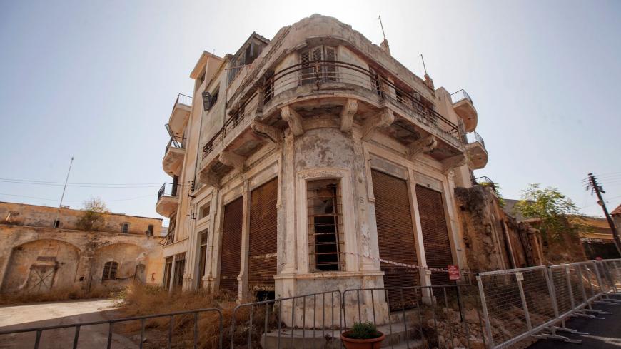 This picture taken on October 8, 2020 shows a view of abandoned buildings along a street in Varosha, in the fenced off area of Famagusta, in the Turkish-occupied north of the divided eastern Mediterranean island of Cyprus. - Turkish troops partially reopened the Cyprus seaside resort of Varosha, sealed off since its Greek Cypriot inhabitants fled in 1974, sparking controversy days before a Turkish Cypriot election. (Photo by Birol BEBEK / AFP) (Photo by BIROL BEBEK/AFP via Getty Images)