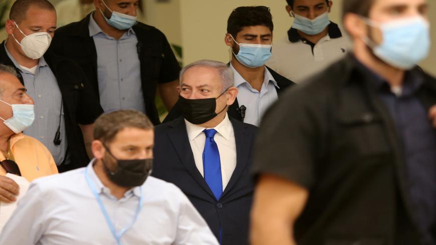 Israeli Prime Minister Benjamin Netanyahu (C) arrives to attend a meeting at the Knesset (Parliament) in Jerusalem on October 15, 2020. (Photo by Alex KOLOMIENSKY / POOL / AFP) (Photo by ALEX KOLOMIENSKY/POOL/AFP via Getty Images)
