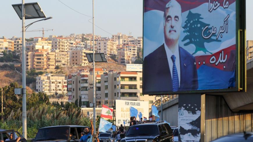 Supporters of Saad Hariri's Future Movement Party wave the party flag and the national flag during a parade to celebrate him being tasked with forming a new government in Lebanon's southern city of Sidon (Saida) on October 22, 2020. - Three-time Lebanese prime minister Saad Hariri was renamed to the post to create a reform-orientated cabinet that can lift the country out of its worst economic crisis in decades. (Photo by Mahmoud ZAYYAT / AFP) (Photo by MAHMOUD ZAYYAT/AFP via Getty Images)