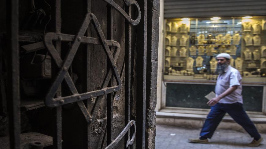 A man walks past a Star of David decorating the door of a home in the Jewish quarter of the Egyptian capital, Cairo, on June 25, 2015. An Egyptian soap opera titled "The Jewish Quarter" aiming to dispel prejudice towards the country's long-vilified and nearly extinct Jewish community is being aired during the holy Muslim fasting month of Ramadan. AFP PHOTO / KHALED DESOUKI (Photo credit should read KHALED DESOUKI/AFP via Getty Images)