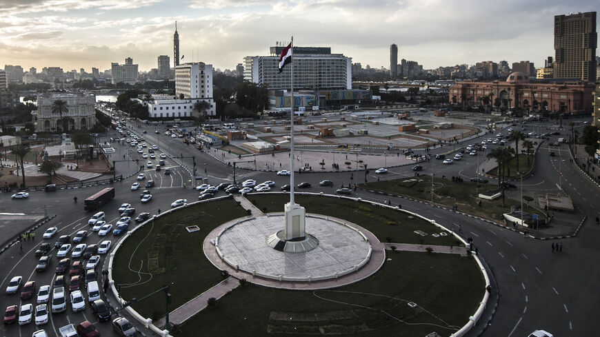 An Egyptian national flag flutters over Cairo's Tahrir Square on January 24, 2016, on the eve of the anniversary of the 2011 uprising. - On January 25, 2011, massive protests against president Hosni Mubarak erupt after a revolt topples Tunisia's ruler in what becomes known as the Arab Spring. On February 1, more than a million demonstrators take to the streets in the country, with a great flood of people congregating in Tahrir Square. (Photo by KHALED DESOUKI / AFP)        (Photo credit should read KHALED D