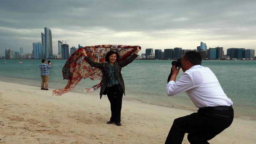 Tourists gather at Abu Dhabi sea front before a heavy rain storm on March 9, 2016.
Schools in the United Arab Emirates were ordered to shut after rare heavy rain hit the desert Gulf state, causing flights to be suspended and flooding roads.

 / AFP / STRINGER        (Photo credit should read STRINGER/AFP via Getty Images)