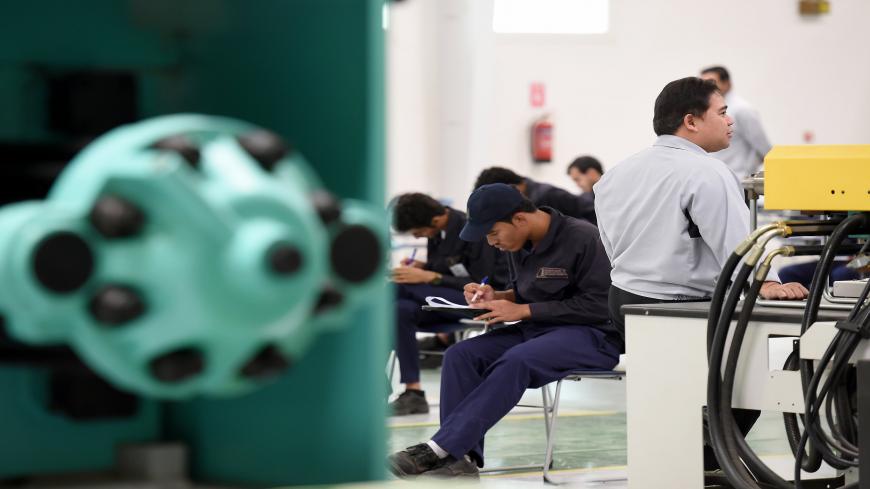 Saudi students pass their final exams at a workshop in the Higher Institute for Plastics Fabrication on June 13, 2016 in Riyadh.
The students at the Higher Institute for Plastics Fabrication (HIPF) learn to manufacture plastic bags, pipes, bottles and other products, skills they immediately put to work in what the government says is a unique model. Reducing the kingdom's high unemployment rate is a foundation -- and major challenge -- of the government's wide-ranging Vision 2030 reform plan unveiled in Apr
