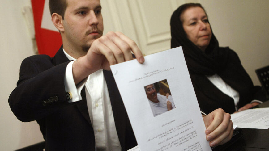 US Daniel Levinson (L) shows a picture of his father, ex-FBI agent Robert Levinson, holding his grandson Ryan during a press conference with his mother Christine at the Swiss embassy in Tehran, 22 December 2007. The wife of the former agent missing in Iran since March said today she has received "no answers" about his fate at the end of her trip to the Islamic republic in search of her husband, who Washington says went missing on a visit to the Iranian island of Kish. The Tehran government reiterated earlie
