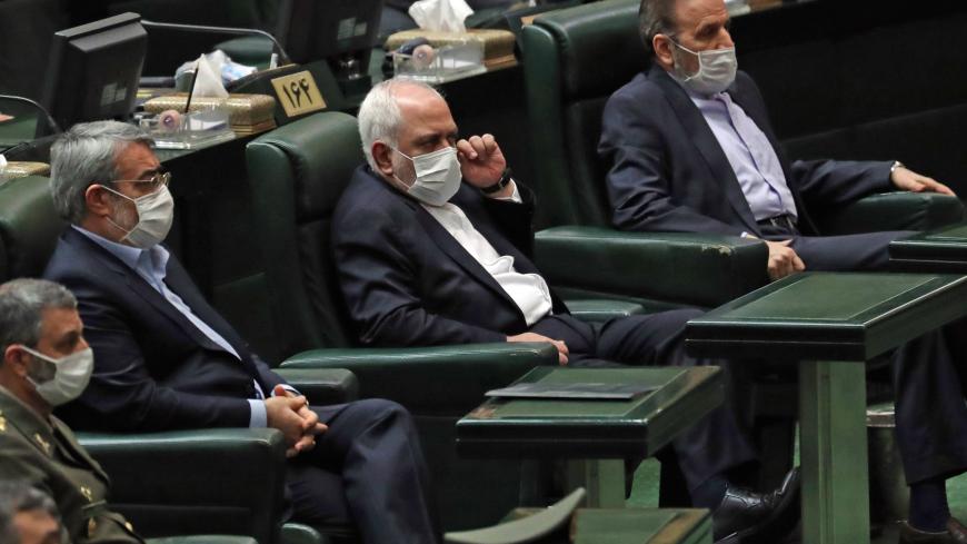 Iranian Foreign Minister Mohmmad Javad Zarif (C) attends during the inaugural session of the new parliament in Tehran on May 27, 2020, following February elections. - The 11th legislature since the Islamic revolution of 1979 opened as the country's economy, which has been hard hit by the novel coronavirus, gradually returns to normal. Rouhani, who is in the final year of his second and final term, called on MPs, collectively and individually, to place the "national interest above special interests", "party 