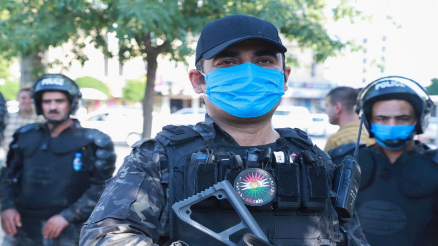 Kurdish riot police, some wearing protective masks due to COVID-19, stand guard during a demonstration to denounce the Turkish assault in northern Iraq, in Sulaimaniyah city, in the Kurdish autonomous region of northern Iraq, on June 18, 2020. - Turkey launched a rare ground assault into northern Iraq on June 17, deploying special forces against rebels from the Kurdistan Workers' Party (PKK) which is blacklisted by Ankara as a "terrorist" group. Baghdad demanded Ankara immediately halt its assault in northe