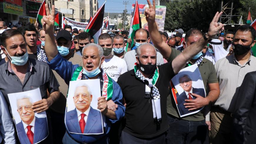 Palestinians carry the portrait of president Mahmud Abbas as they gather to commemorate the second intifada and to protest the Israeli normalisation deals with the United Arab Emirates and Bahrain, in the town of Tubas, in the occupied West Bank on September 27, 2020. - The second intifada lasted five years, during which attacks were carried out in Israel, the Gaza Strip and the West Bank. In response Israel reoccupied much of the West Bank and began building a separation barrier between the two communities