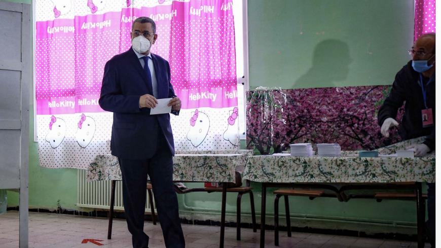 Algerian Prime Minister Abdelmadjid Djerad prepares to cast his ballot at a polling station in the capital Algiers, during a vote for a revised constitution, on November 1, 2020 - Polls opened in Algeria today for a vote on a revised constitution the regime hopes will neutralise a protest movement which at its peak last year swept long-time president Abdelaziz Bouteflika from power. (Photo by - / AFP) (Photo by -/AFP via Getty Images)