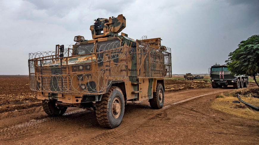 A picture shows a joint Turkish-Russian military patrol, in the countryside of the Syrian town of Darbasiyah near the Turkish border in the northeastern province of Hasakah, on November 5, 2020. (Photo by Delil SOULEIMAN / AFP) (Photo by DELIL SOULEIMAN/AFP via Getty Images)