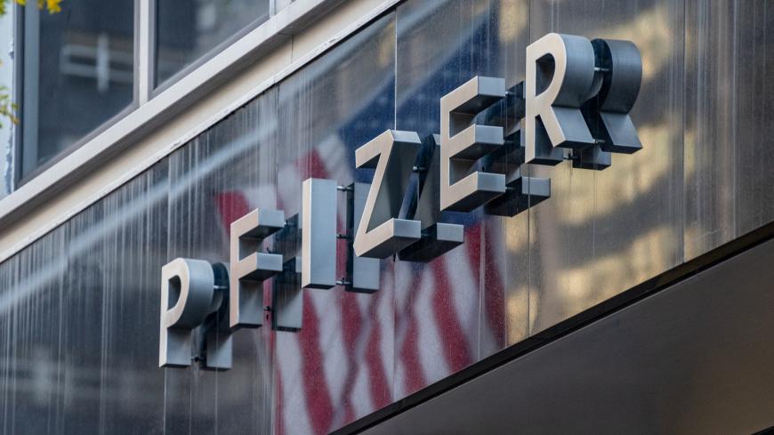 NEW YORK, NY - NOVEMBER 09: People walk by the Pfizer headquarters on November 9, 2020 in New York City. Pharmaceutical company Pfizer announced positive early results on its COVID-19 vaccine trial and has proven to be 90% effective in preventing infection of the virus. (Photo by David Dee Delgado/Getty Images)