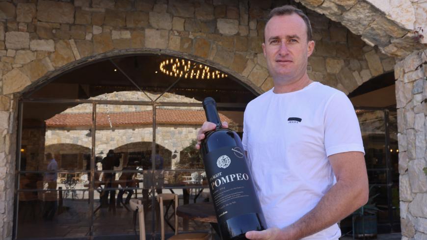 Israeli winemaker Yaakov Berg's holds a bottle of his red blend named after US Secretary of State Mike Pompeo at the Psagot Winery in the settlers industrial park of Sha'ar Binyamin near the Israeli Psagot settlement in the occupied West Bank north of Jerusalem on November 18, 2020. - Berg's decision to name his red blend after US Secretary Mike Pompeo may capture attention, but for him the hashtag on the label's top right corner "#madeinlegality" is just as important, categorically rejecting the notion tha