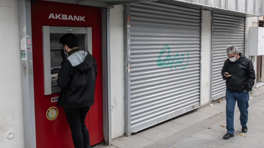 ISTANBUL, TURKEY - NOVEMBER 09: A man uses an automated teller machine (ATM) at a Turkey's Akbank branch on November 09, 2020 in Istanbul, Turkey. Finance Minister Berat Albayrak, the son-in-law of President Erdogan who has been in the role for five years, resigned Sunday citing health reasons. The country's currency has plunged 30 percent this year. After the resignation of Berat Albayrak, Turkish lira gained 3% against $ following the resignation. (Photo by Burak Kara/Getty Images)