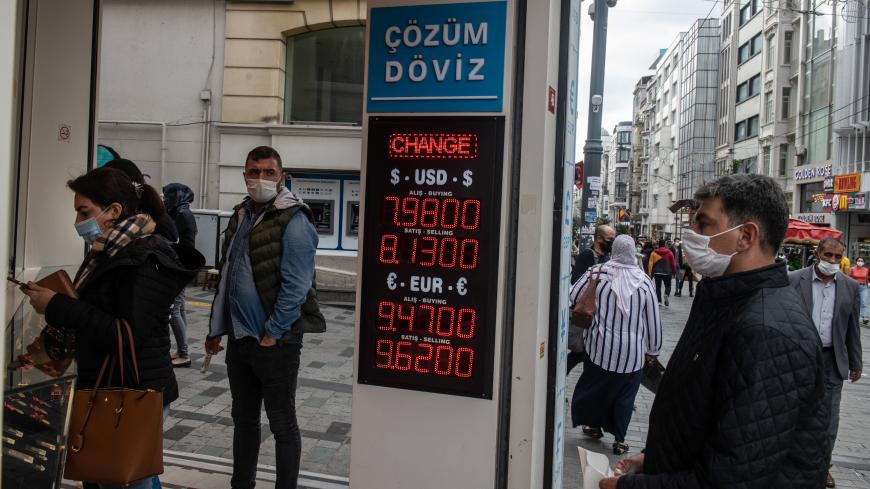 ISTANBUL, TURKEY - NOVEMBER 09: People wait to exchange money at a currency exchange shop on November 09, 2020 in Istanbul, Turkey. Finance Minister Berat Albayrak, the son-in-law of President Erdogan who has been in the role for five years, resigned Sunday citing health reasons. The country's currency has plunged 30 percent this year. After the resignation of Berat Albayrak, Turkish lira gained 3% against $ following the resignation. (Photo by Burak Kara/Getty Images)