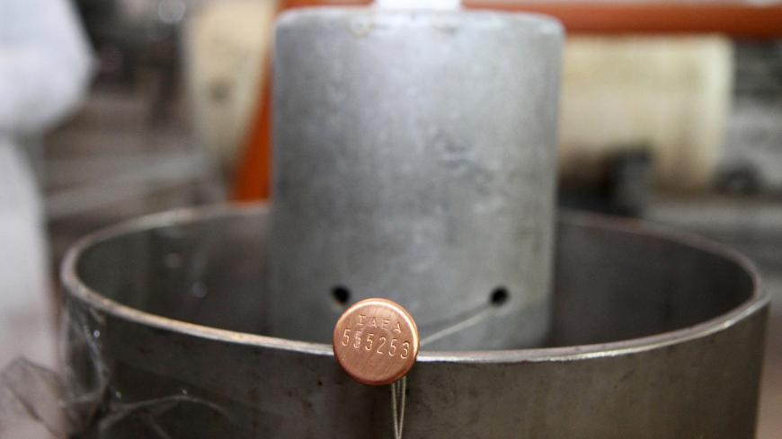 A picture shows the seal of the connections between the twin cascades for 20 percent uranium production bearing the initials of the International Atomic Energy Agency (IAEA) after they were disconnected at nuclear power plant of Natanz, some 300 kilometres south of Tehran on January, 20, 2014 as Iran halted production of 20 percent enriched uranium, marking the coming into force of an interim deal with world powers on its disputed nuclear programme. AFP PHOTO/IRNA/KAZEM GHANE        (Photo credit should rea