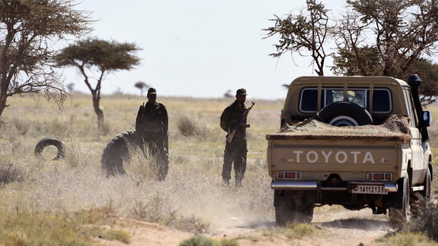 Members of the Polisario Front stand guard during a visit of the United Nations chief on March 5, 2016, in Bir-Lahlou, in the disputed territory of Western Sahara, situated 220 kilometres (137 miles) southwest of the Algerian town of Tindouf.
UN Secretary General Ban Ki-Moon, who met Polisario Front leaders including its Secretary General, said he would "spare no effort" in trying to find a solution to the Western Sahara issue. / AFP / Farouk Batiche        (Photo credit should read FAROUK BATICHE/AFP via G