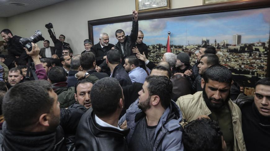 Members of the Palestinian Islamist Hamas movement is greeted by supporters before at the movement's leader Ismail Haniyeh's office in the Gaza Strip on February 28, 2019. - The Hamas leader announced in a press release today the release of four detainees from his group held in Egypt since August 2015. (Photo by MAHMUD HAMS / AFP) (Photo credit should read MAHMUD HAMS/AFP via Getty Images)