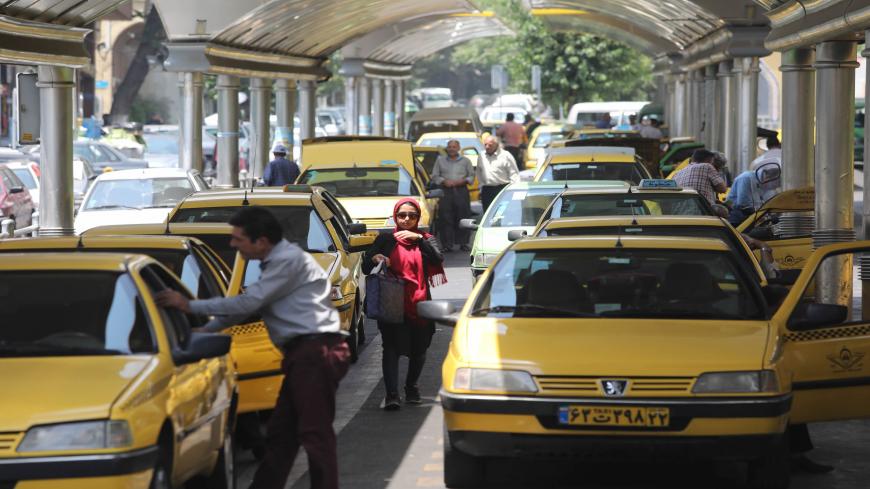 Taxis line up to pick up customers at a taxi station in the Iranian capital Tehran on July 3, 2019. - The Iranian economy is struggling in part because of the crippling US sanctions targeting Iran's oil sales, banking transactions and major industries like steel and petrochemicals. (Photo by ATTA KENARE / AFP)        (Photo credit should read ATTA KENARE/AFP via Getty Images)