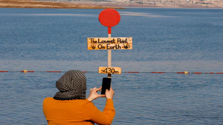 A Palestinian woman takes a picture at the Dead Sea near the city of Jericho in the occupied West Bank on August 2, 2020 during the Eid al-Adha holiday. (Photo by HAZEM BADER / AFP) (Photo by HAZEM BADER/AFP via Getty Images)