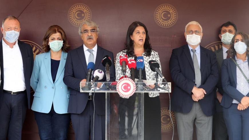 Co-chairmans of the pro-Kurdish Peoples' Democratic Party (HDP) Pervin Buldan (C-R) and Mithat Sancar (C-L) hold a press conference with their parliament members as they boycott the first sessiom of the Grand National Assembly's 27th term following the arrest of 82 people, including members of their party, outside the Parliament building in Ankara on October 1, 2020. - Turkish prosecutors on October 1 issued arrest warrants for 82 people, including a mayor and several former lawmakers from the pro-Kurdish H