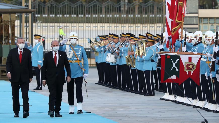 President of Turkey Recep Tayyip Erdogan (L) welcomes Turkish-Cypriot leader Ersin Tatar (R) during an official ceremony in Ankara, on October 26, 2020. - Ankara-backed Ersin Tatar, the newly elected Turkish Cypriot leader, makes his first official visit in Ankara on October 26, 2020. (Photo by Adem ALTAN / AFP) (Photo by ADEM ALTAN/AFP via Getty Images)