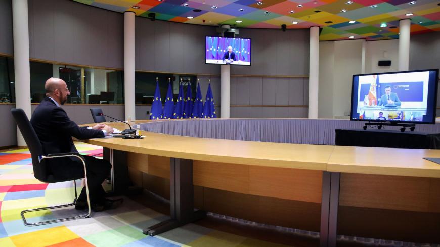 European Council President Charles Michel speaks with Spanish Prime Minister Pedro Sanchez (on screen) as he attends a video conference with representatives of EU member states ahead of the upcoming EU summit, in Brussels, on December 3, 2020. - The summit will take place on December 10, 2020. (Photo by François WALSCHAERTS / POOL / AFP) (Photo by FRANCOIS WALSCHAERTS/POOL/AFP via Getty Images)