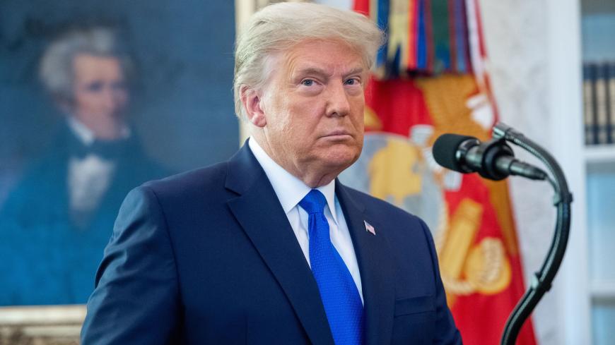 TOPSHOT - US President Donald Trump looks on during a ceremony presenting the Presidential Medal of Freedom to wrestler Dan Gable in the Oval Office of the White House in Washington, DC on December 7, 2020. (Photo by SAUL LOEB / AFP) (Photo by SAUL LOEB/AFP via Getty Images)
