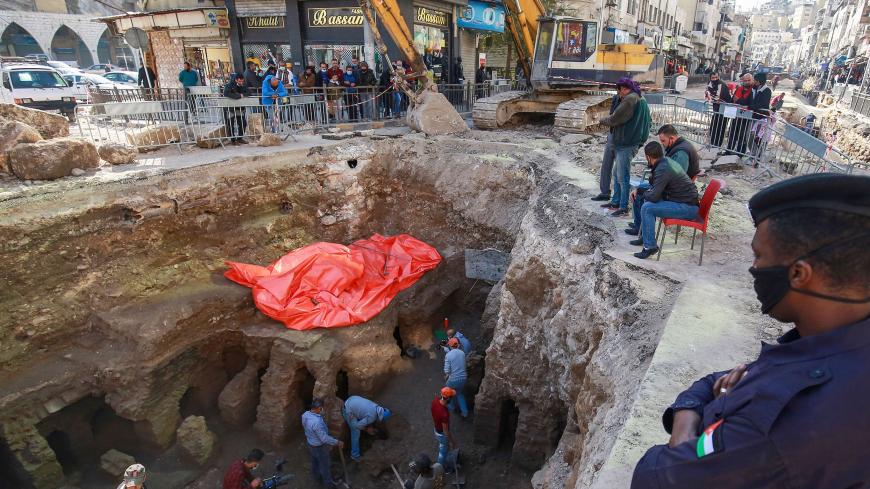 People watch as workers uncover the ruins of a recently discovered Roman archaeological site in the Jordanian capital Amman, on December 14, 2020. - According to local media, the archaeological site was uncovered during works to install a water drainage system. (Photo by Khalil MAZRAAWI / AFP) (Photo by KHALIL MAZRAAWI/afp/AFP via Getty Images)