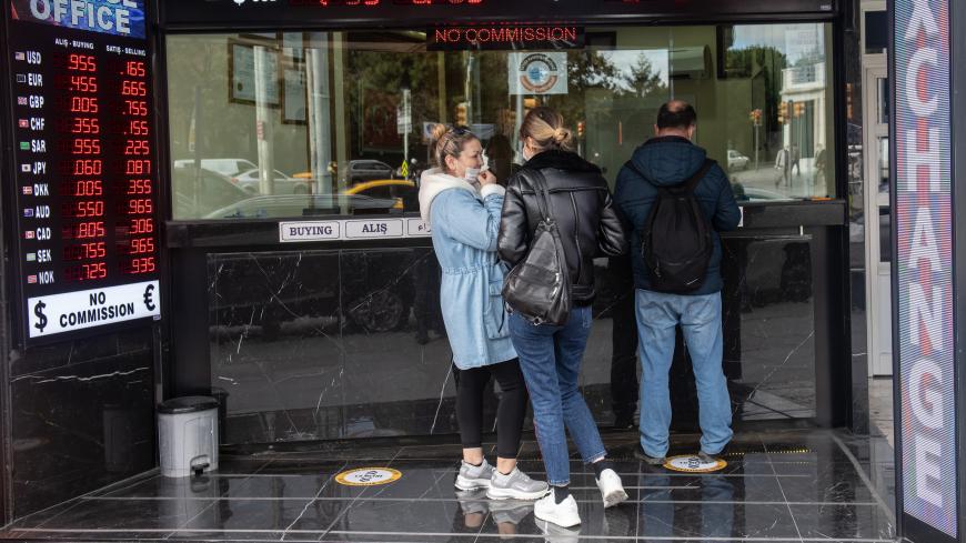 ISTANBUL, TURKEY - NOVEMBER 09: People wait to exchange money at a currency exchange shop on November 09, 2020 in Istanbul, Turkey. Finance Minister Berat Albayrak, the son-in-law of President Erdogan who has been in the role for five years, resigned Sunday citing health reasons. The country's currency has plunged 30 percent this year. After the resignation of Berat Albayrak, Turkish lira gained 3% against $ following the resignation. (Photo by Burak Kara/Getty Images)