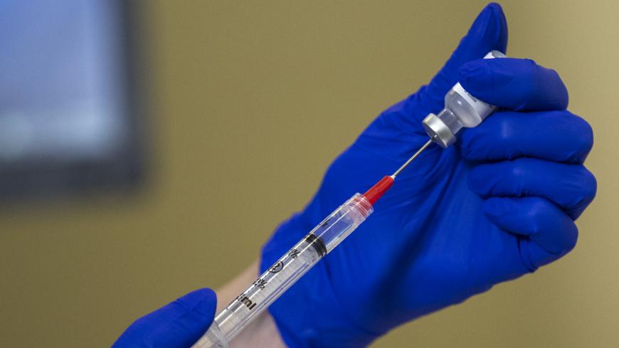 WASHINGTON, DC - DECEMBER 17: The Pfizer-BioNTech COVID-19 vaccine being prepared prior to a vaccine event at Kaiser Permanente Capitol Hill Medical Center on December 17, 2020 in Washington, DC. (Photo by Shawn Thew-Pool/Getty Images)